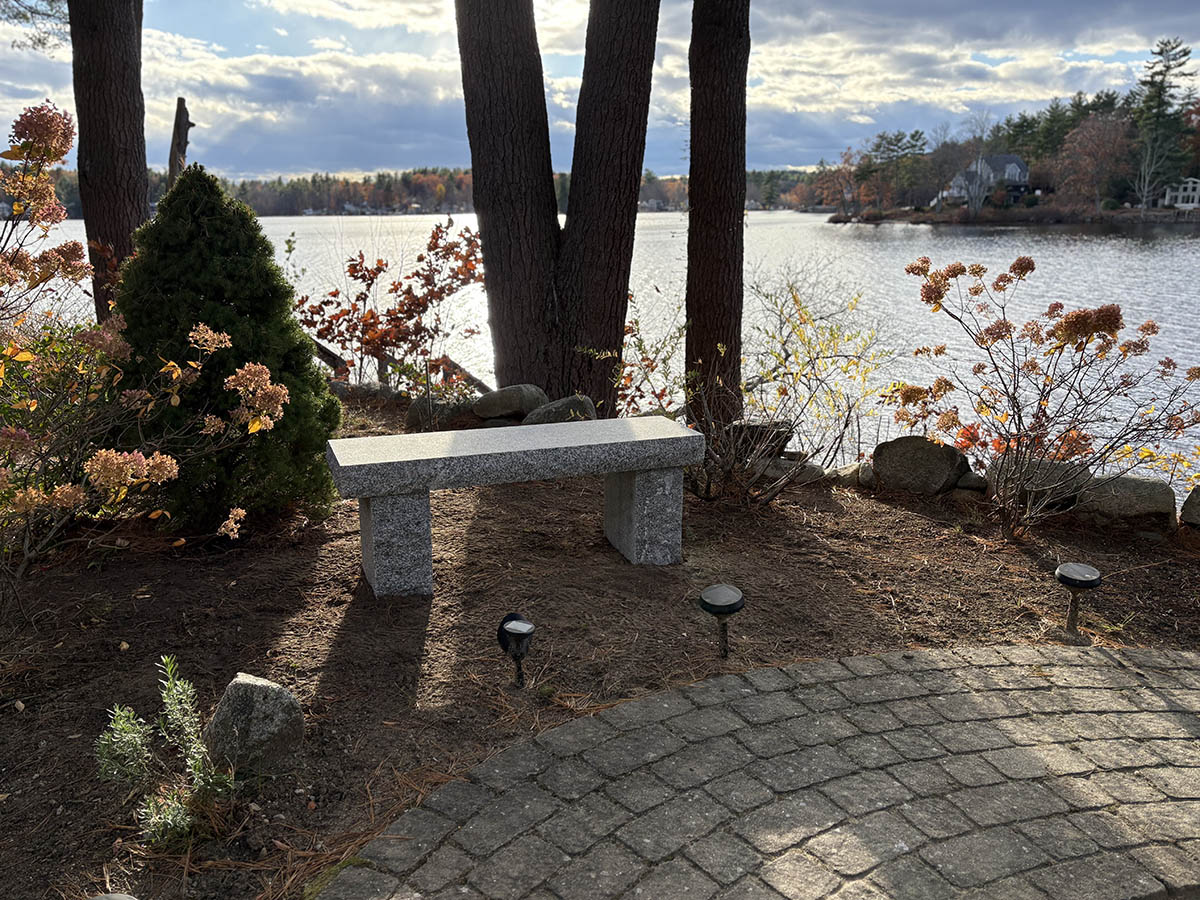 a bench in front of a lake